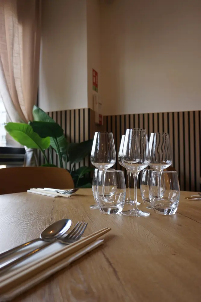 Verres, couverts et baguettes sur une table en bois